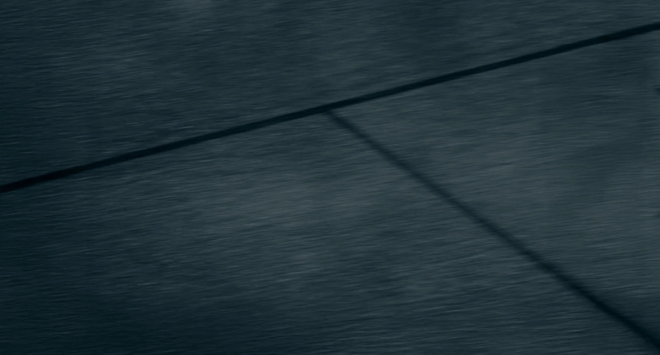 Dark textured surface with a diagonal line