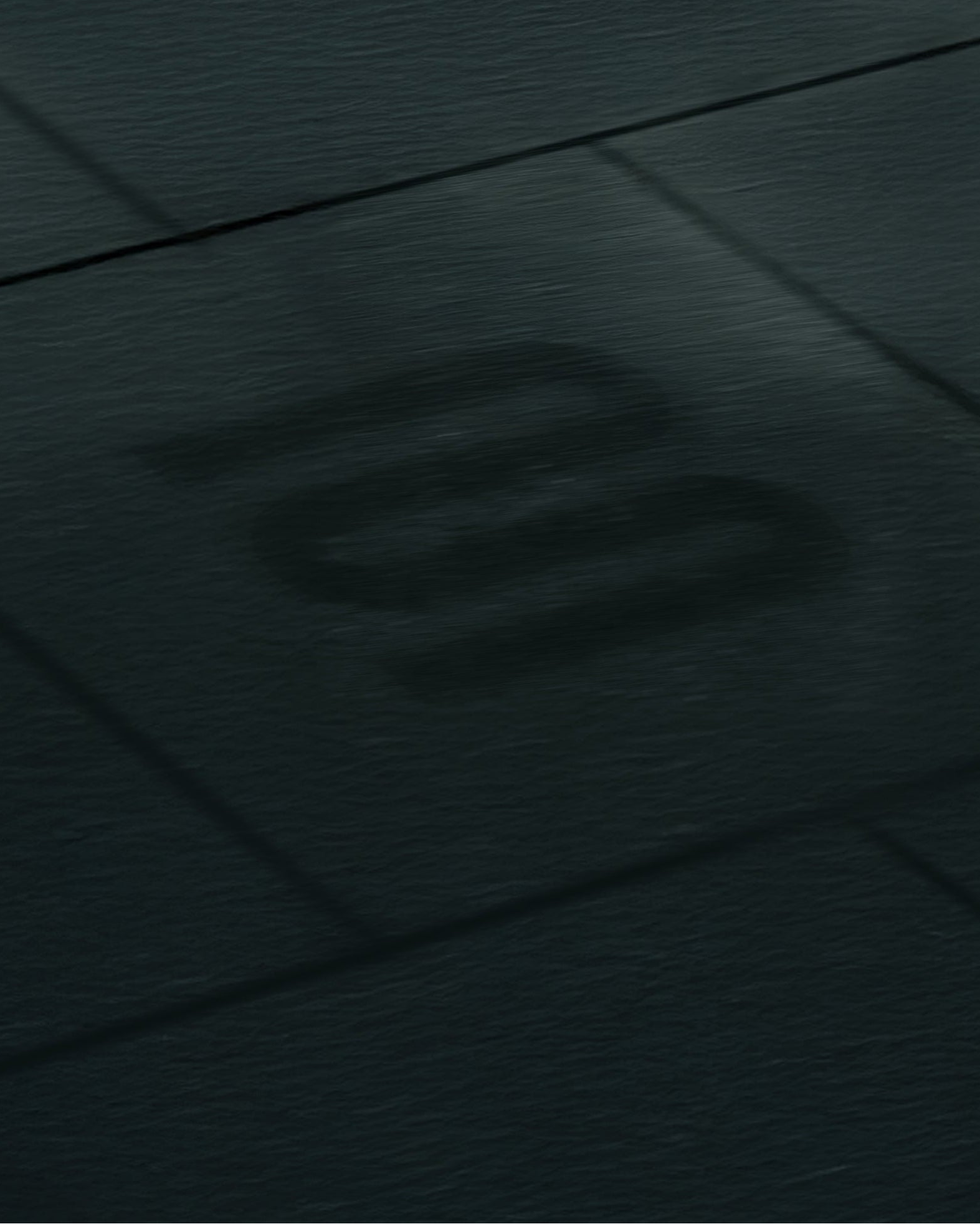 Close-up of a textured dark surface with a logo.