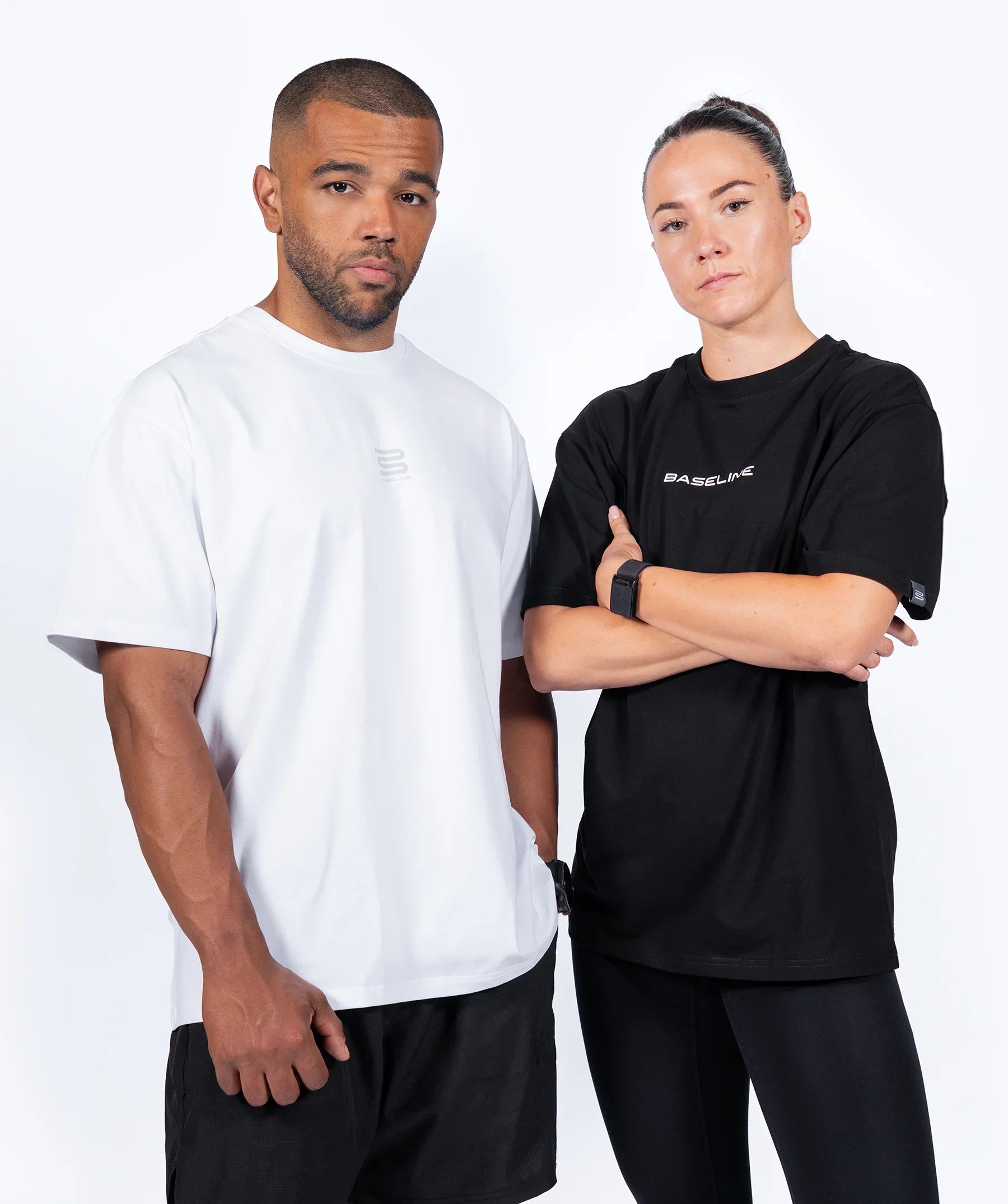 Two people wearing white and black t-shirts with a brand logo on a white background