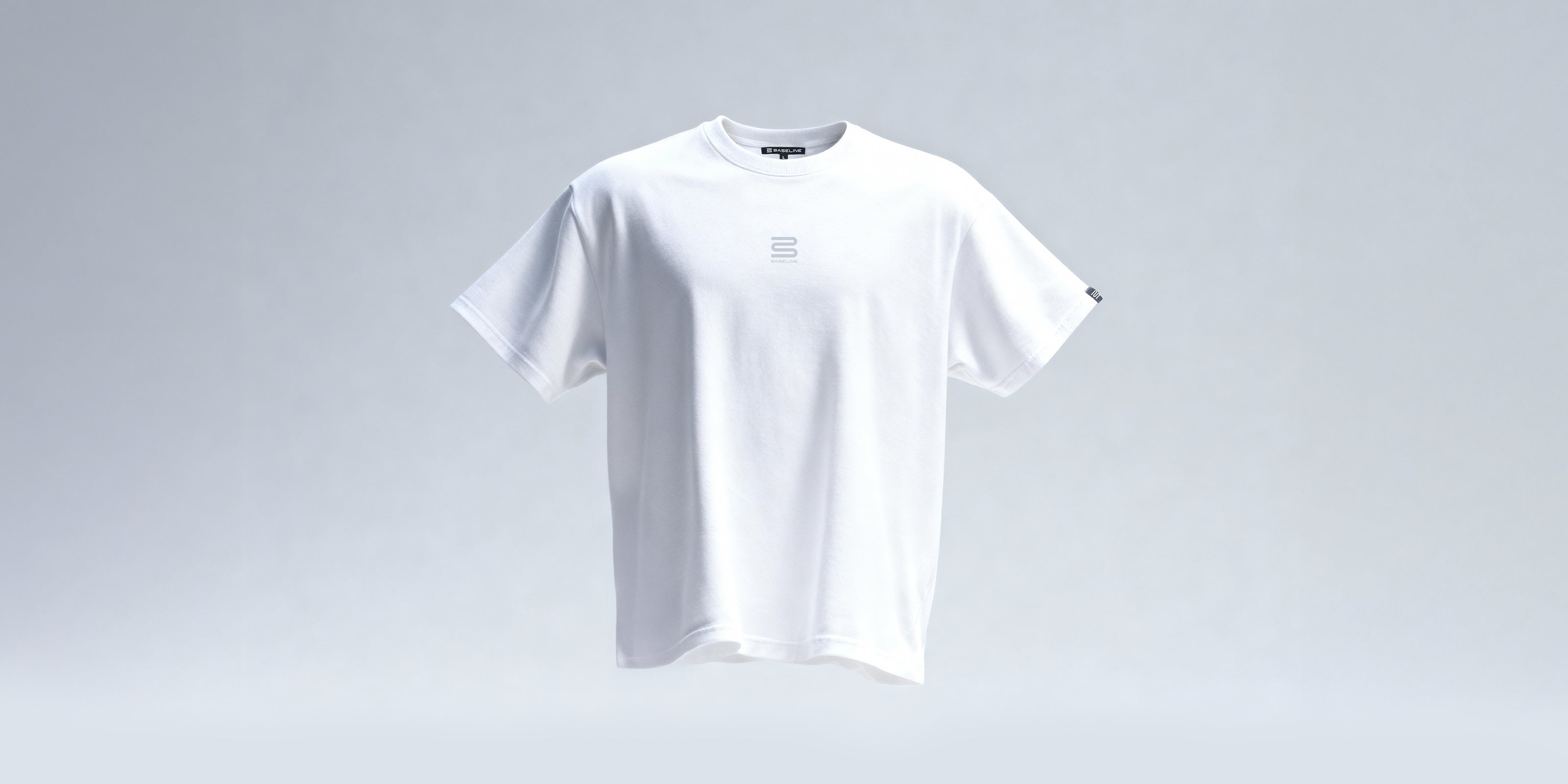 White athletic t-shirt with subtle front logo, short sleeves, and relaxed fit on light background