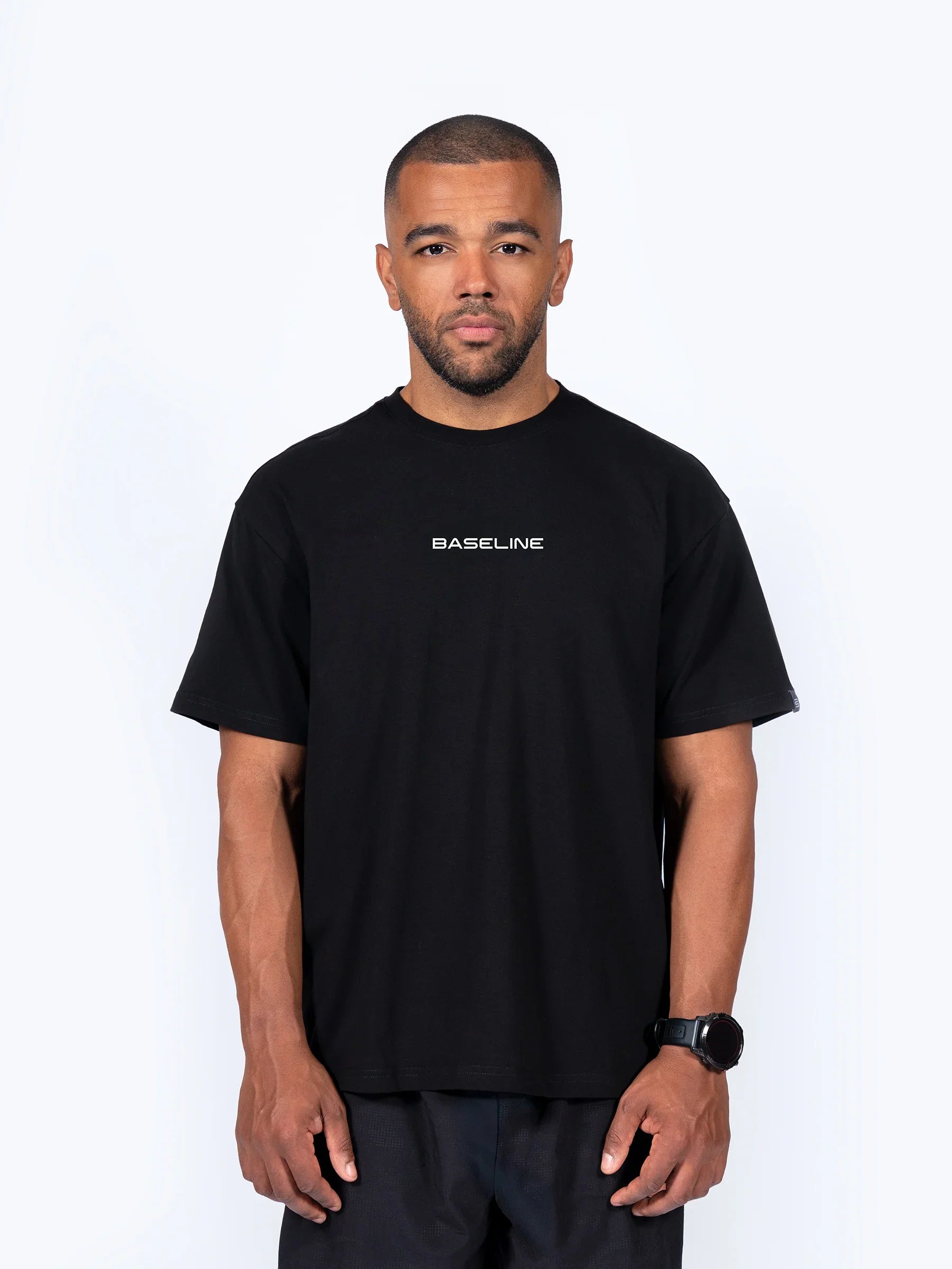 Male athlete wearing black 'Icon Oversized' t-shirt with white background